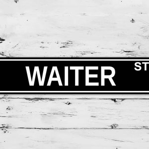 May include: Black and white street sign with the text "WAITER ST" in white letters.