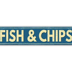 May include: A blue and white vintage-style metal sign with the text "FISH & CHIPS" in white letters.