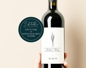 May include: A printable wine bottle label with a minimalist design featuring a sprig of greenery and the text "Aiden & Lily" and the date "06 | 30 | 23". The label is editable in Corjl and can be downloaded and printed at home.