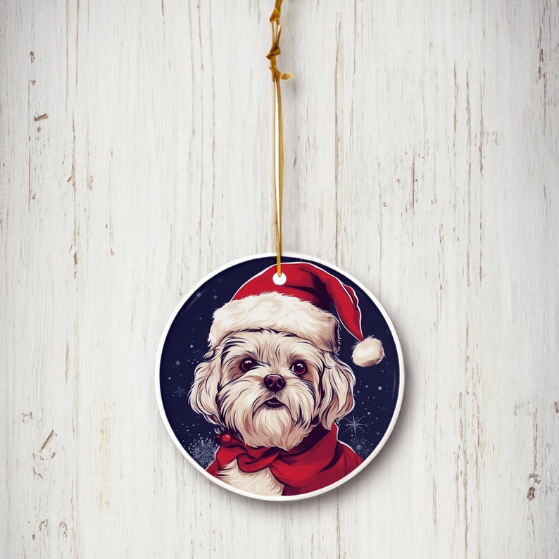 Elevate your holiday decor with our 3" ceramic Maltese Santa Hat ornament. Perfect for dog lovers, this limited-edition design adds festive charm to your Christmas tree. Order now for a touch of holiday magic!