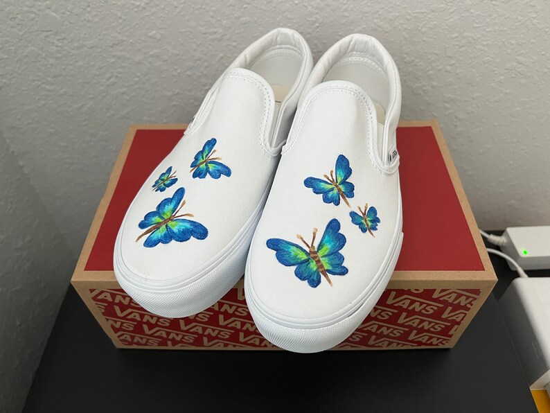 white vans with blue butterflies