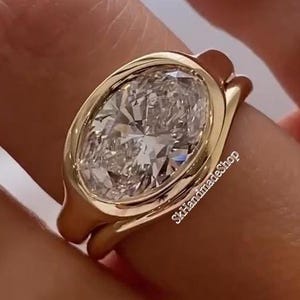 East To West 3CT Oval Cut Moissanite Bezel Set Solitaire Ring, Paired With Matching Curved Shape Plain Band, 14K Yellow Gold Bridal Ring Set