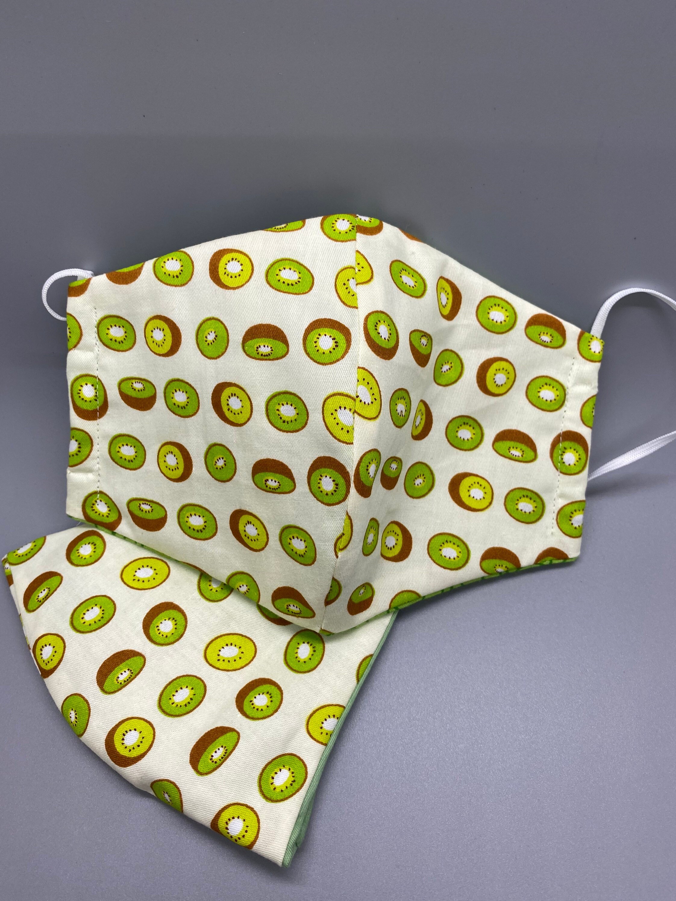 Kiwi face mask. Has three layers. Comes with adhesive nose Etsy