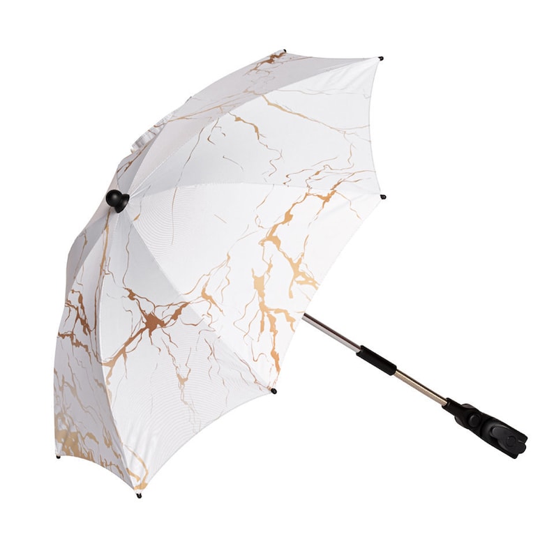 May include: White stroller sunshade with a gold marble pattern. The sunshade has a black metal frame and a universal clamp.