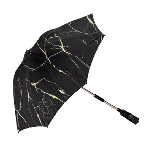 May include: Black and gold stroller sunshade with a marble pattern. The sunshade has a black metal frame and a black plastic clip for attaching to a stroller.