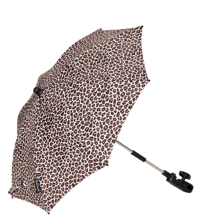 May include: A black and white leopard print stroller sunshade with a black metal frame and a black clamp. The sunshade is designed to attach to a stroller.