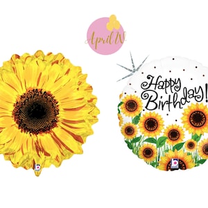 May include: Two sunflower-themed birthday balloons. One balloon features a single large sunflower with yellow petals and a brown center. The other balloon has a white background with the text "Happy Birthday!" and several smaller sunflowers.
