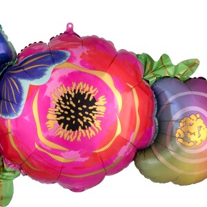 May include: A set of three foil balloons shaped like flowers and a butterfly. The flowers are pink, purple, and green with gold accents. The butterfly is blue and green with gold accents.