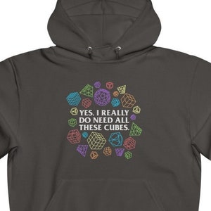 May include: A dark grey hooded sweatshirt with a colourful geometric design and the text "YES, I REALLY DO NEED ALL THESE CUBES."