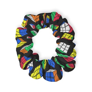 May include: A black scrunchie with a colorful Rubik's Cube pattern.