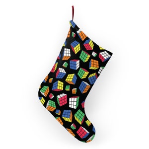 May include: A black Christmas stocking with a pattern of colorful Rubik's Cubes.