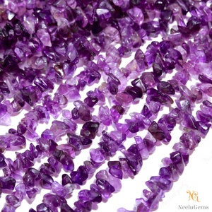 May include: A strand of purple amethyst chip beads. The beads are irregular in shape and have a natural, rough texture.