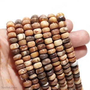 May include: A strand of brown, beige and white banded agate beads. The beads are round and have a smooth, polished finish.