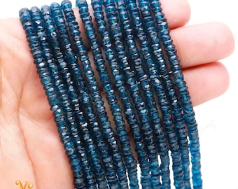 May include: A strand of blue gemstone beads, faceted and round, with a slight shimmer. The beads are strung on a clear thread and are approximately 3mm in diameter.