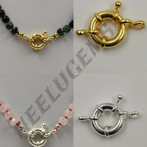 May include: Two different types of clasps for necklaces. The top clasp is gold and the bottom clasp is silver.