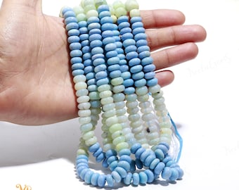 May include: A strand of light blue and white gemstone beads. The beads are round and have a smooth, polished finish. The beads are strung on a clear elastic cord.