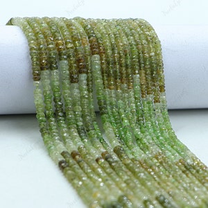 May include: A strand of green and brown gemstone beads. The beads are faceted and have a slightly irregular shape. The beads are strung on a clear thread and are ready to be used for jewellery making.