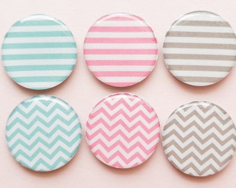 Pink, blue, and gray magnets