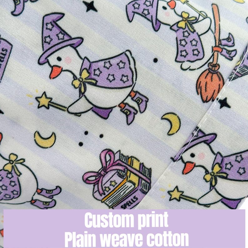 May include: A custom print fabric featuring a repeating pattern of cartoon geese dressed as witches, with purple hats and capes, flying on brooms and holding wands. The background has light purple stripes. The text reads "Custom print Plain weave cotton."