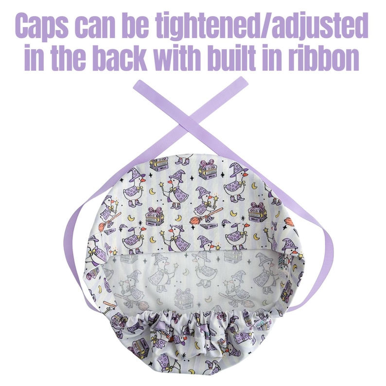 May include: A white patterned cap with a witch duck design, featuring a purple ribbon for adjustment. The cap has a repeating pattern of witch ducks, gift boxes, and moons. The text "Caps can be tightened/adjusted in the back with built in ribbon" is at the top.