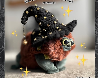 May include: A plush toy creature wearing a black witch hat adorned with gold stars. The toy has large, expressive eyes and a furry, reddish-brown body. The text "WITCH HAT PLUSH ACCESSORY PDF PATTERN" is visible.