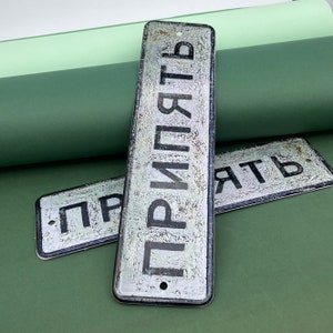Letrero de metal "PRYPIAT" / (en ucraniano) Copia del cartel soviético real, que también se puede ver en el territorio de la zona de exclusión de Chernóbil.