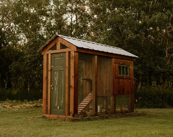 May include: A wooden chicken coop with a green door and a metal roof. The coop has a nesting box, a ramp, and a wire mesh enclosure.