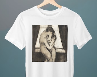 May include: A white t-shirt featuring a black and white drawing of two figures embracing in front of a window. The drawing is in a sketchy style and appears to be a reproduction of a famous artwork.