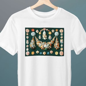 May include: White t-shirt with a colorful image of a seashell garland with flowers and faces on a green background.