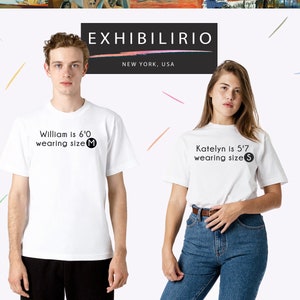 May include: Two people wearing white t-shirts with black text. The text on the shirts reads "William is 6'0 wearing size M" and "Katelyn is 5'7 wearing size S".