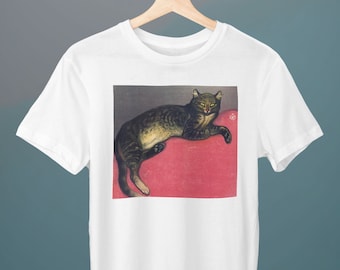 May include: A white t-shirt with a print of a tabby cat lying on a red cushion. The cat has green eyes and a black nose.