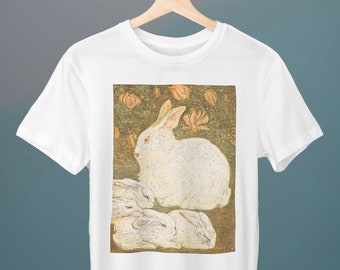 May include: White t-shirt with a graphic print of a white rabbit and three smaller rabbits in a green and brown floral setting.