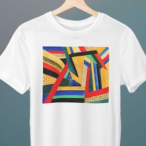 May include: White t-shirt with a colorful abstract design featuring geometric shapes in red, yellow, blue, green, and black.