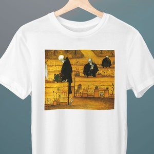 May include: A white t-shirt with a graphic print of a painting depicting skeletons tending to a garden. The painting is in a yellow, brown, and green color scheme.