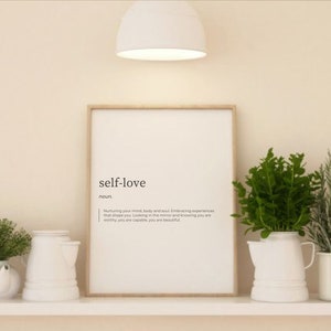 May include: A framed print with the word "self-love" defined as "Nurturing your mind, body and soul. Embracing experiences that shape you. Looking in the mirror and knowing you are worthy, you are capable, you are beautiful."