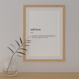 May include: A framed print with the word "self-love" defined as "Nurturing your mind, body and soul. Embracing experiences that shape you. Looking in the mirror and knowing you are worthy, you are capable, you are beautiful."