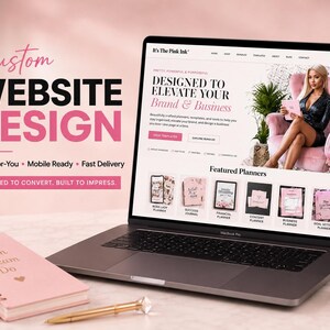 May include: A laptop displaying a website titled It's The Pink Ink with the text Custom Website Design, Done-For-You, Mobile Ready, Fast Delivery, and Designed to convert. Built to impress. A pink spiral notebook and a gold pen sit on the table.