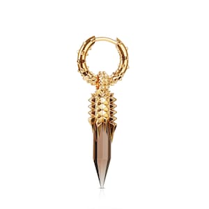 May include: Gold hoop earring with a spike pendant featuring a brown crystal. The hoop is adorned with small spikes.
