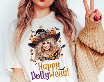 May include: White t-shirt with a graphic of Dolly Parton dressed as a witch with a guitar and pumpkins. The text "Happy Dollyween!" is printed below the graphic.