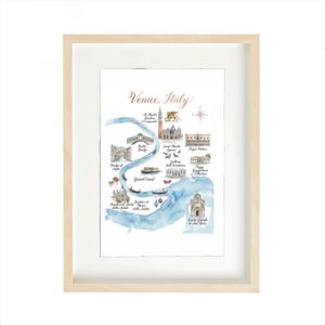 Puede incluir: Impresión de mapa en acuarela de Venecia, Italia, con el Gran Canal y lugares emblemáticos. La obra de arte está enmarcada en un marco de madera clara con un passe-partout blanco. El título "Venice, Italy" está escrito en una elegante escritura.