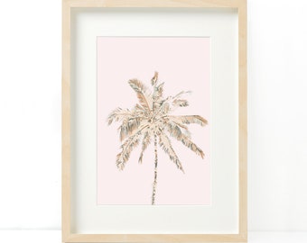 May include: A framed art print featuring a stylized palm tree illustration. The artwork showcases a beige and light green palm tree against a soft pink background. The print is encased in a light wood frame, creating a minimalist aesthetic.