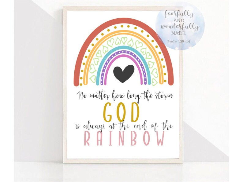 May include: A framed print featuring a colorful rainbow design with a black heart in the center. The text reads "No matter how long the storm, GOD is always at the end of the RAINBOW." A small circular graphic says "fearfully and wonderfully MADE Psalm 139:14."