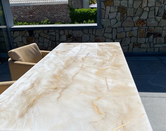 Resin art dining table. Custom made with pouring techniques. White and gold marble design.