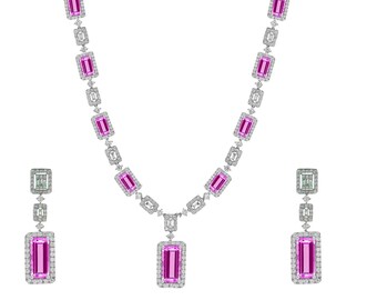 May include: A pink sapphire and diamond necklace and earrings set. The necklace features a pendant with a large rectangular pink sapphire surrounded by smaller diamonds. The earrings are drop earrings with a smaller rectangular pink sapphire surrounded by diamonds.