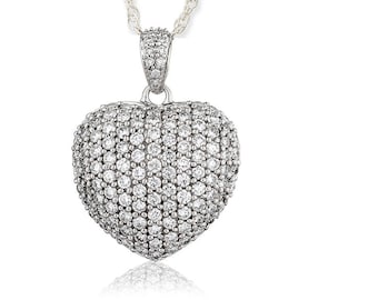 May include: A silver necklace with a heart-shaped pendant encrusted with clear cubic zirconia stones.