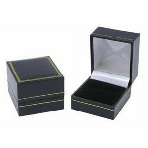 K&ouml;nnte beinhalten: Zwei schwarze Ringboxen mit goldenen Verzierungen. Die Box auf der linken Seite ist geschlossen, w&auml;hrend die Box auf der rechten Seite ge&ouml;ffnet ist und ein schwarzes Samt-Innenleben zeigt.
