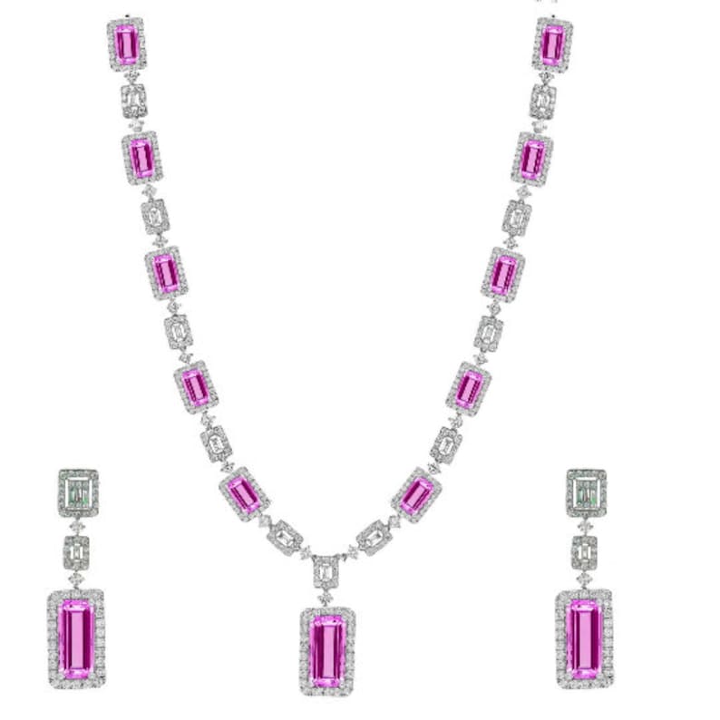 May include: A pink and white diamond necklace and earrings set. The necklace features a pendant with a large pink rectangular stone surrounded by smaller diamonds. The earrings are drop earrings with a pink rectangular stone and smaller diamonds.