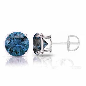 May include: A pair of round blue gemstone stud earrings with a silver setting. The earrings have a push-back closure.