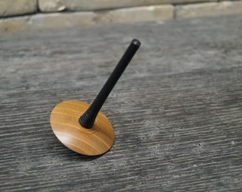 Spinning top made of ebony and cherry wood