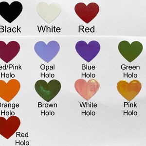 May include: A collection of heart-shaped stickers in various colors, including black, white, red, and holographic shades of red/pink, opal, blue, green, orange, brown, white, and pink. Each heart has a color label.